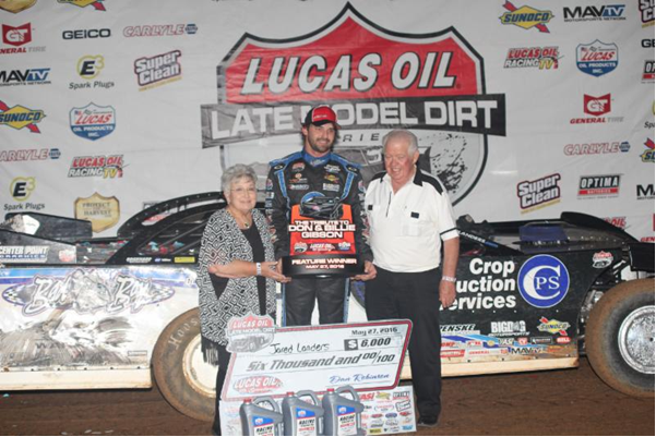 Billie and Don Gibson present the trophy to Jared Landers after Landers' triumph in Friday night's feature at Lucas Oil Speedway. (Chris Bork photo)